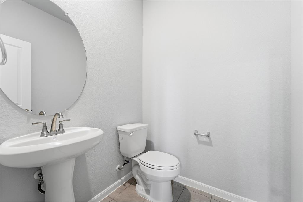 343 Caviar Road Waxahachie, TX 75165 - Photo 21 of 22 a bathroom with a toilet sink and mirror