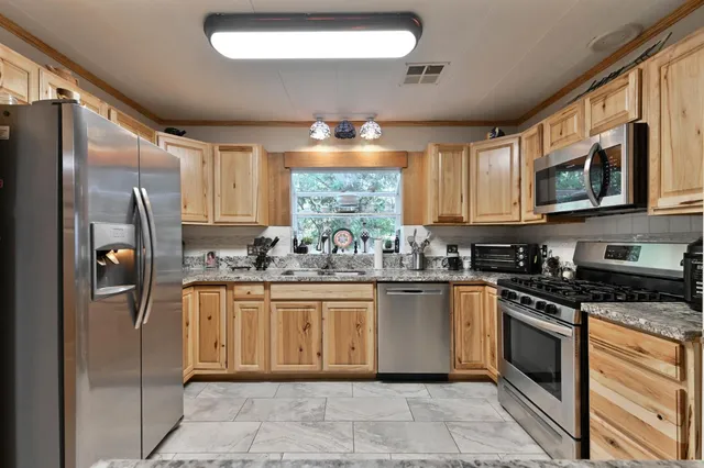 a view of a dining room with furniture large windows and wooden floor