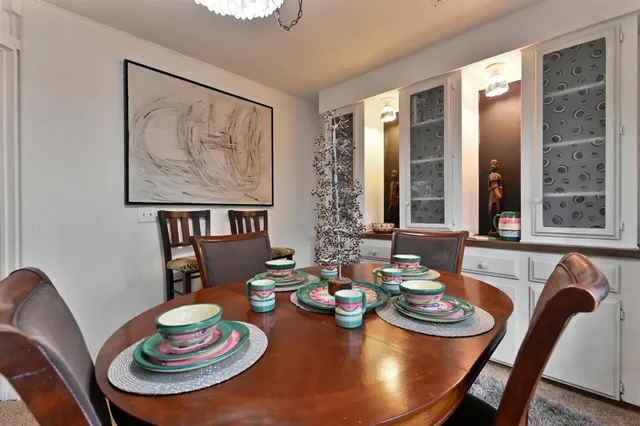 a living room with furniture a rug and a large window
