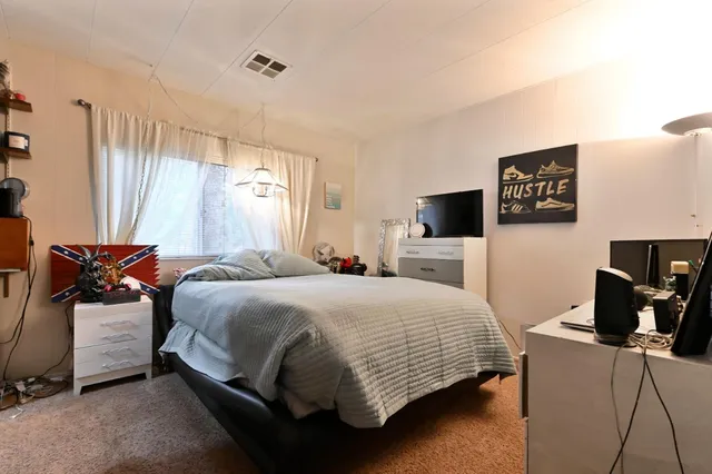 a bedroom with a bed and a television