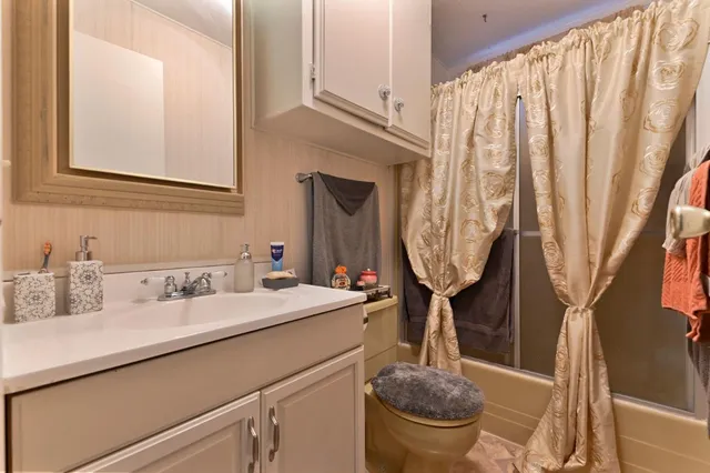 a view of a yard with wooden fence