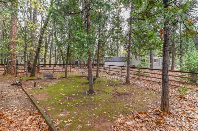 a view of outdoor space with deck area and trees