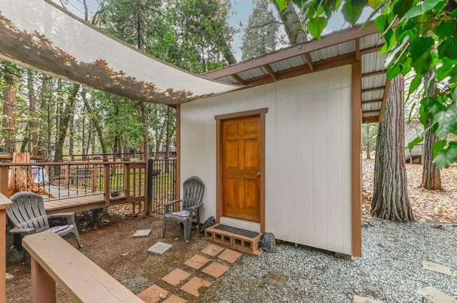 a view of a wooden house with a door and wooden floor