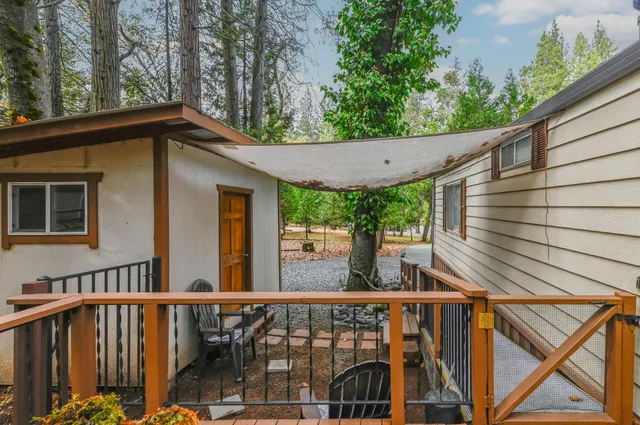 a balcony with wooden floor table and chairs