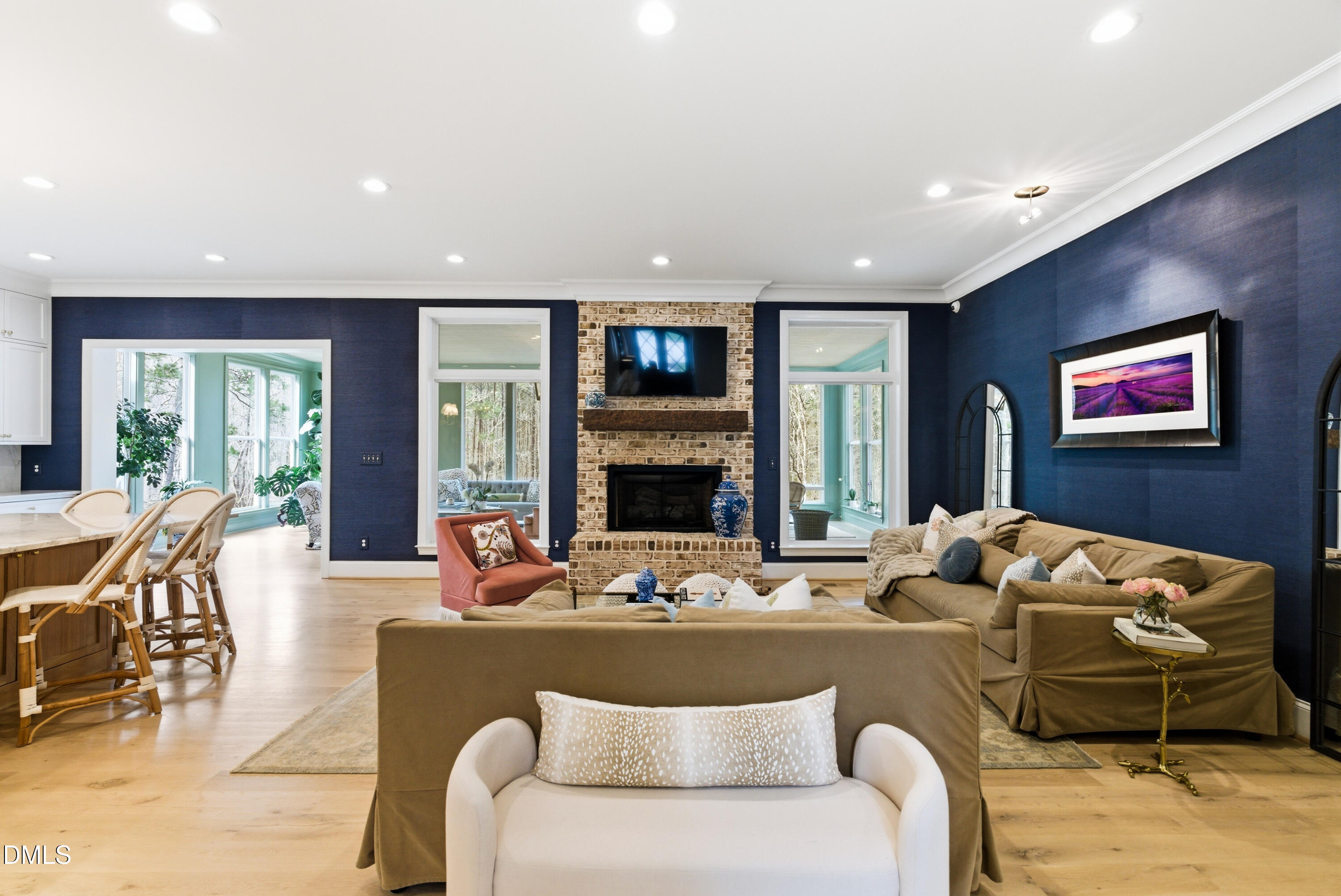 1528 Eglantyne Court Raleigh, NC 27613 - Photo 19 of 99 a living room with furniture a fireplace and a flat screen tv