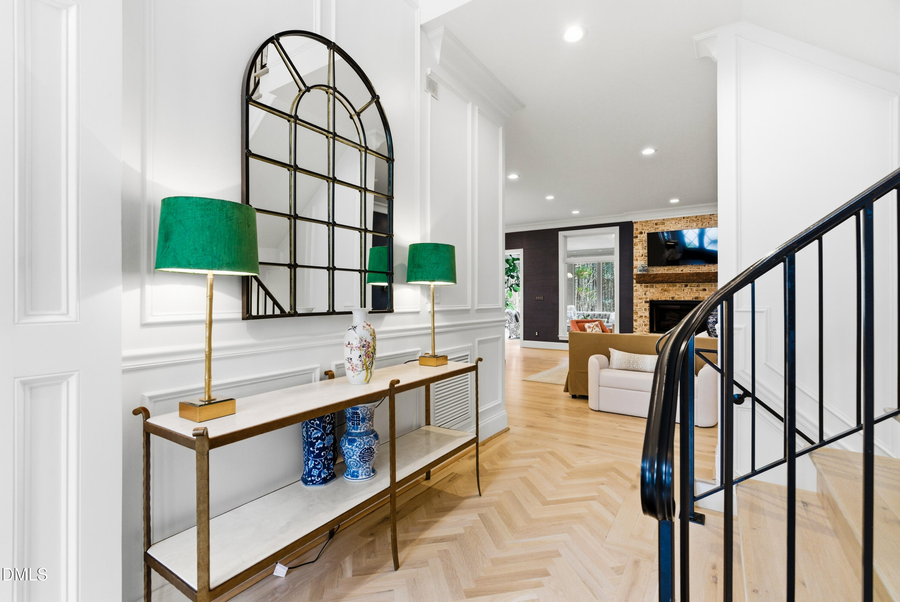 1528 Eglantyne Court Raleigh, NC 27613 - Photo 33 of 99 a kitchen with stainless steel appliances kitchen island a table chairs in it and wooden floors