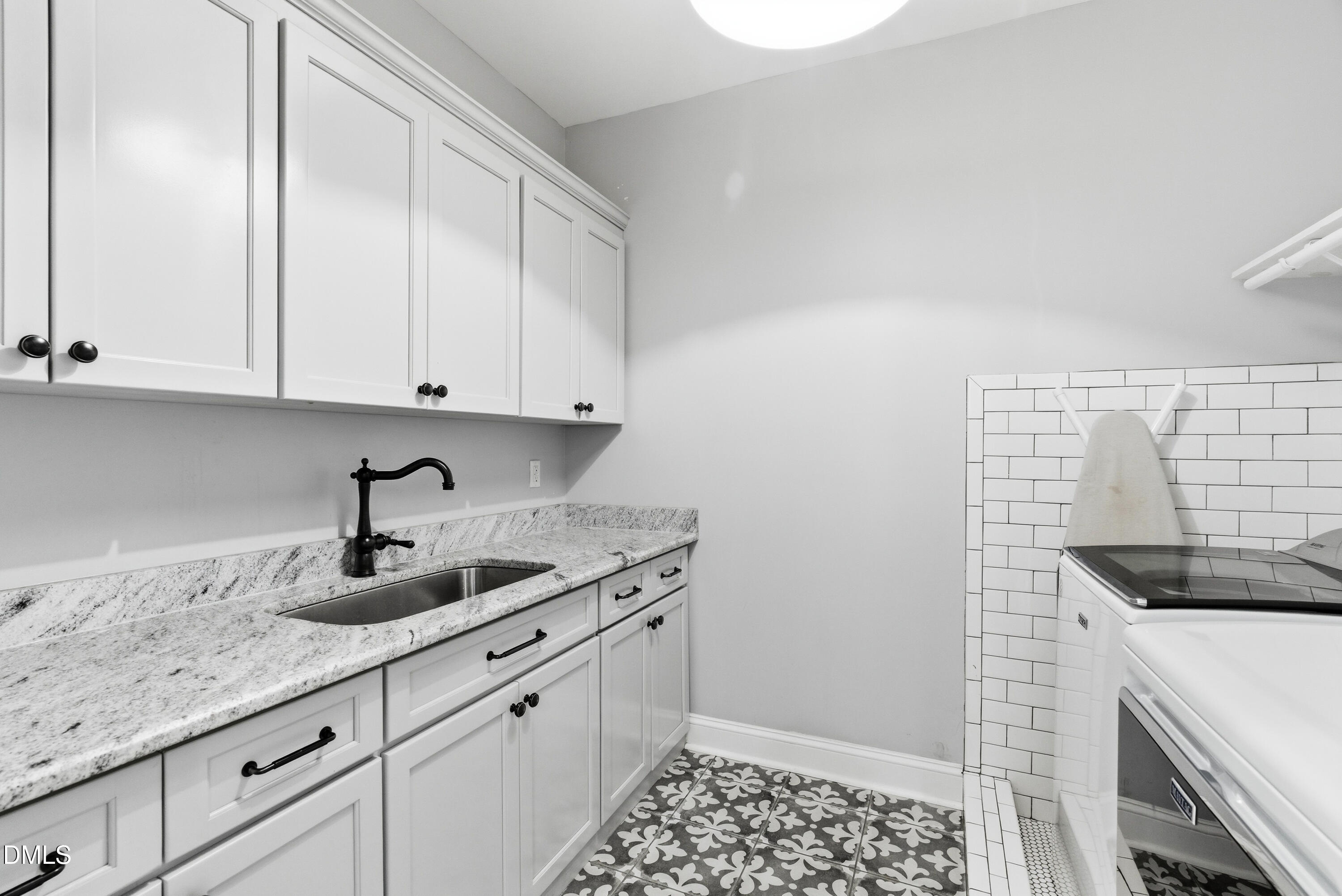 1528 Eglantyne Court Raleigh, NC 27613 - Photo 52 of 99 a kitchen with granite countertop white cabinets and white appliances