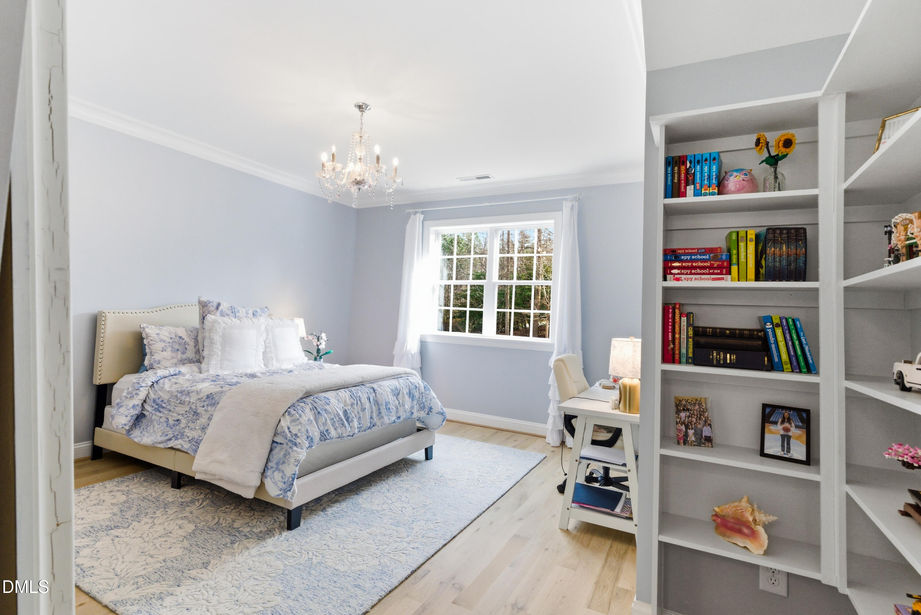 1528 Eglantyne Court Raleigh, NC 27613 - Photo 53 of 99 a bedroom with a bed book shelf and a window