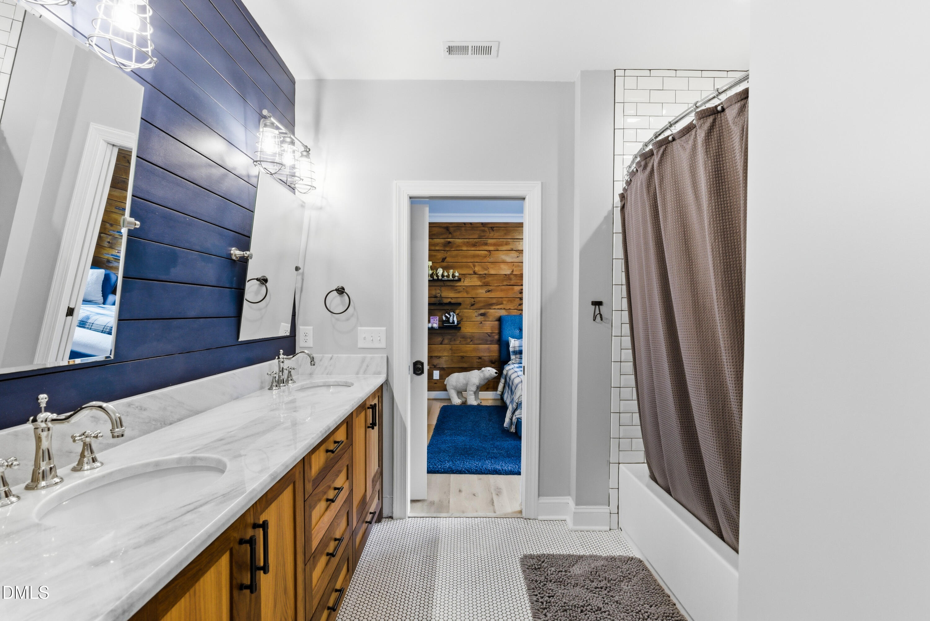 1528 Eglantyne Court Raleigh, NC 27613 - Photo 62 of 99 a bathroom with a double vanity sink and a mirror