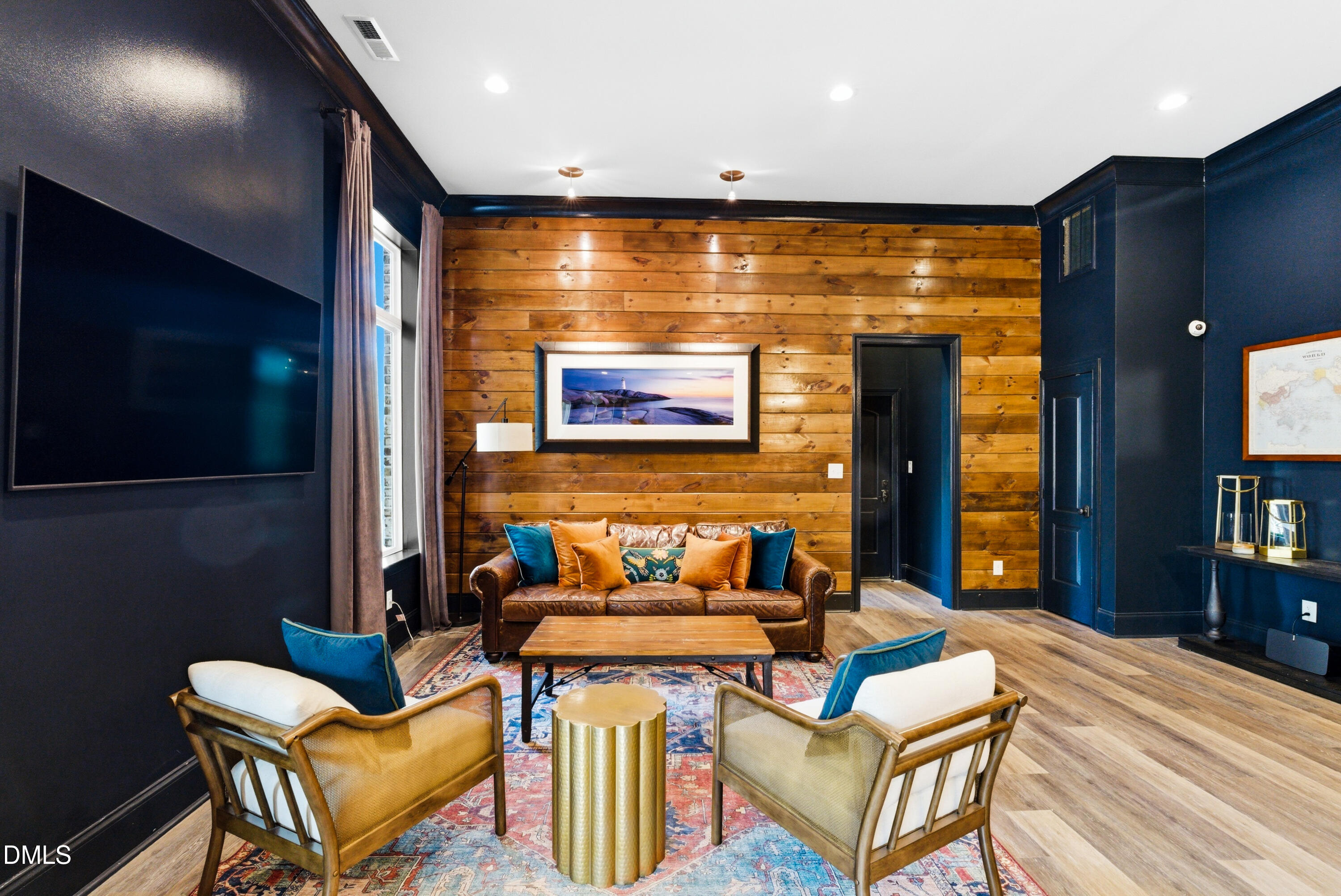 1528 Eglantyne Court Raleigh, NC 27613 - Photo 72 of 99 a living room with furniture a projector and a flat screen tv