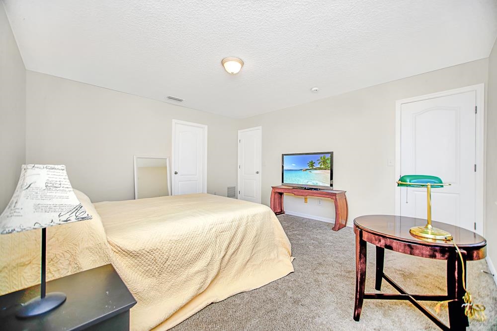 499 Cabernet Place St. Augustine, FL 32084 - Photo 11 of 30 a bedroom with a bed and a table