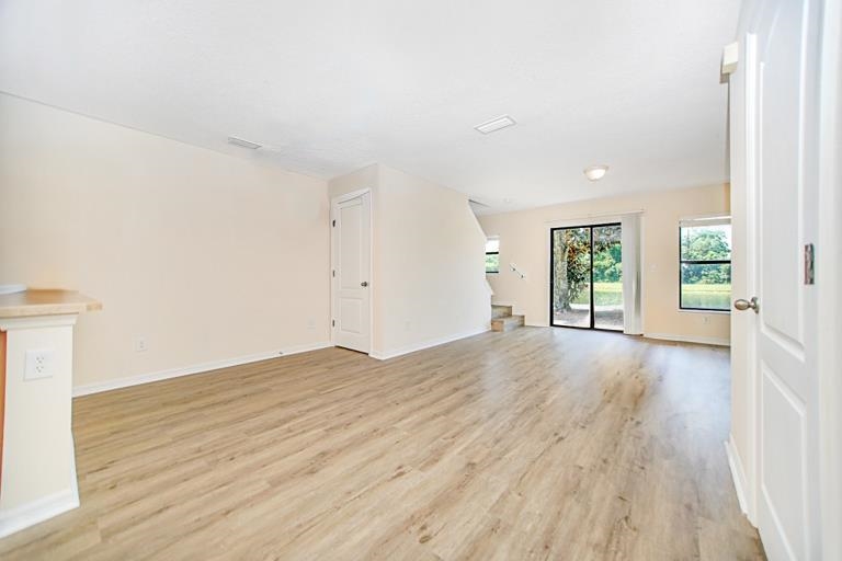 499 Cabernet Place St. Augustine, FL 32084 - Photo 22 of 30 an empty room with wooden floor and windows