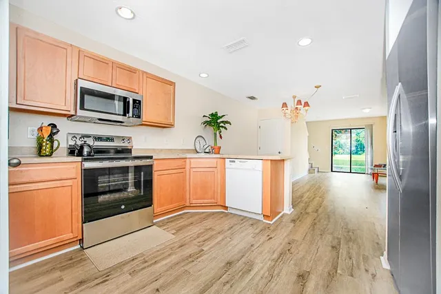 a kitchen with a sink and steel appliances