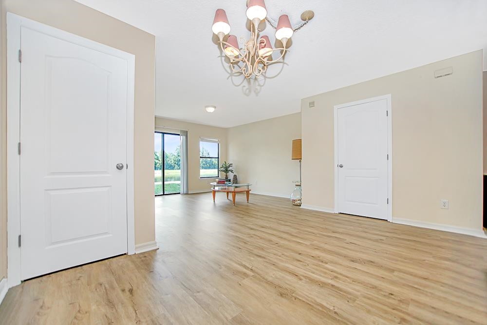 499 Cabernet Place St. Augustine, FL 32084 - Photo 6 of 30 a view of a livingroom with wooden floor and a chandelier