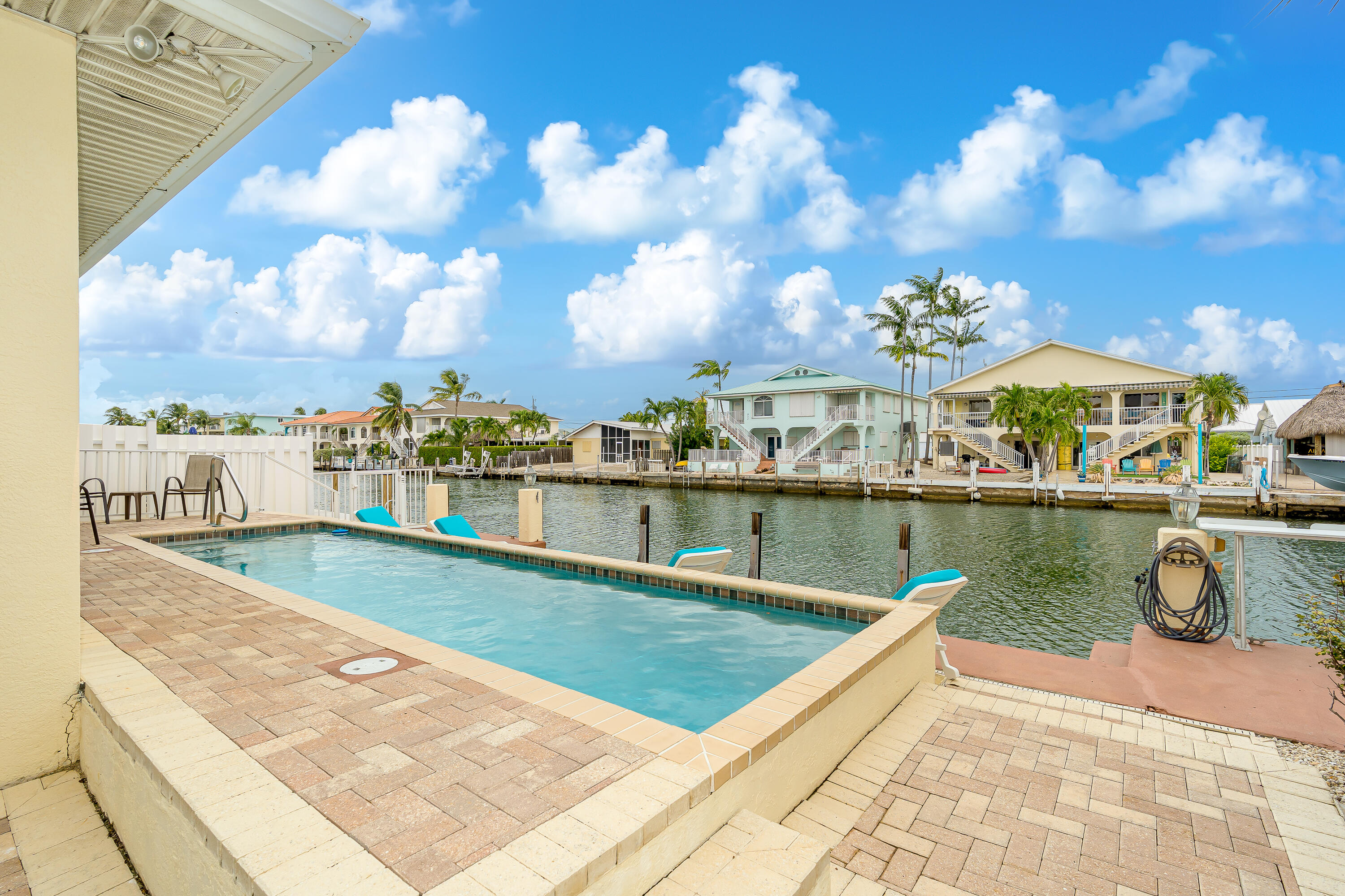 260 Sadowski Causeway Key Colony Beach, FL 33051 - Photo 12 of 50 a view of swimming pool with outdoor seating
