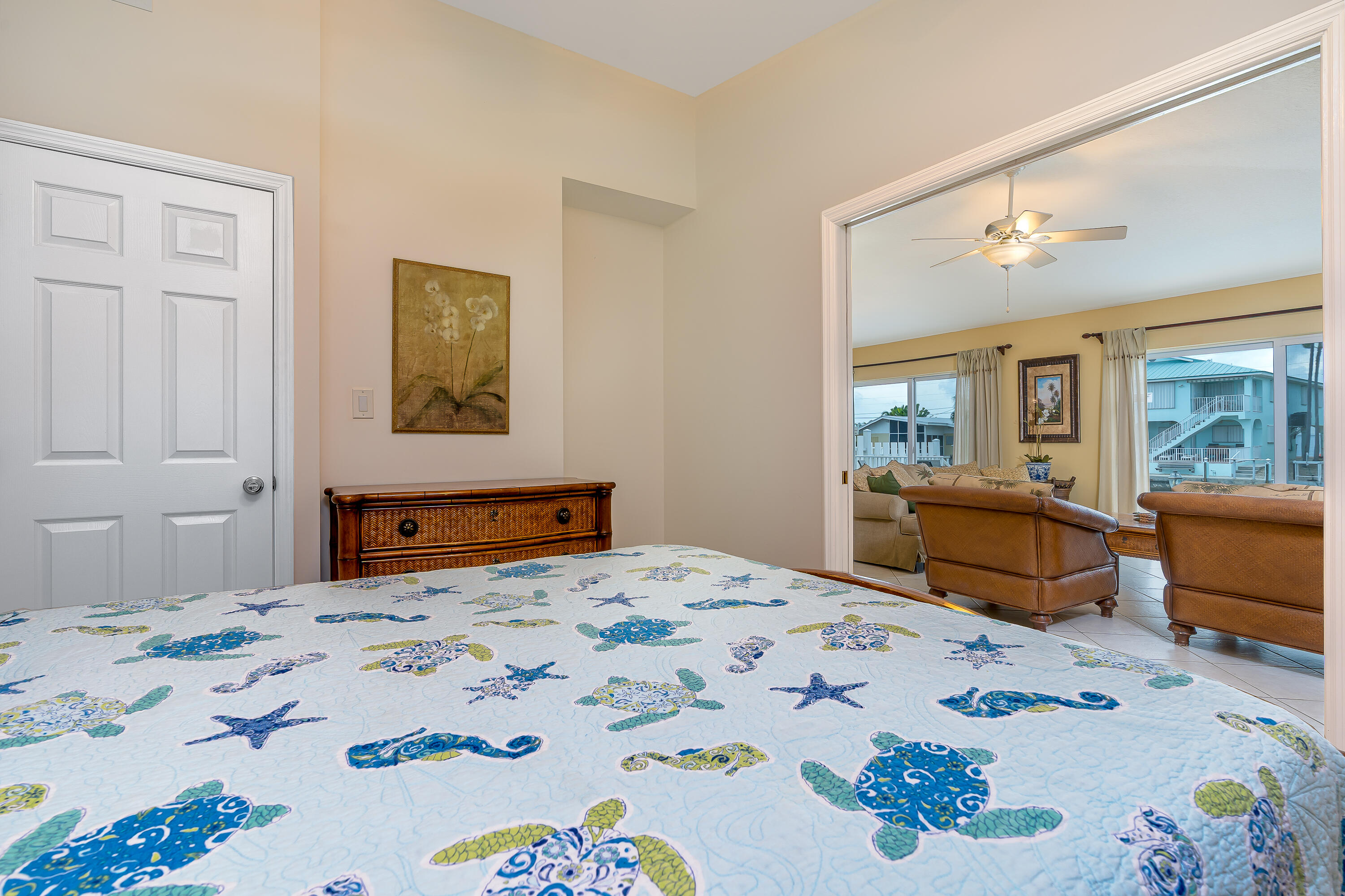 260 Sadowski Causeway Key Colony Beach, FL 33051 - Photo 15 of 50 a bedroom with a bed dresser and wooden floor