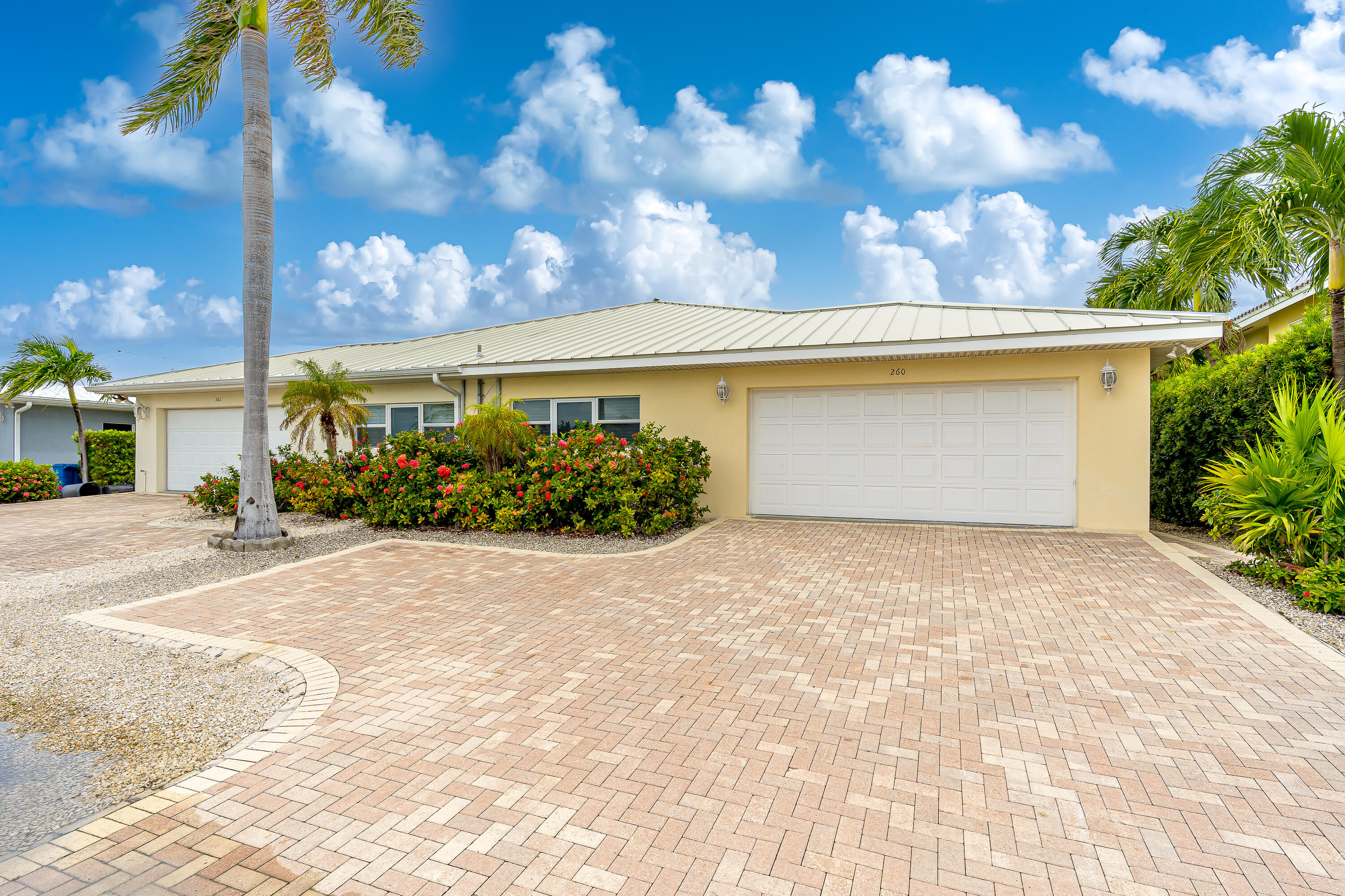 260 Sadowski Causeway Key Colony Beach, FL 33051 - Photo 35 of 50 a front view of a house with a yard and garage