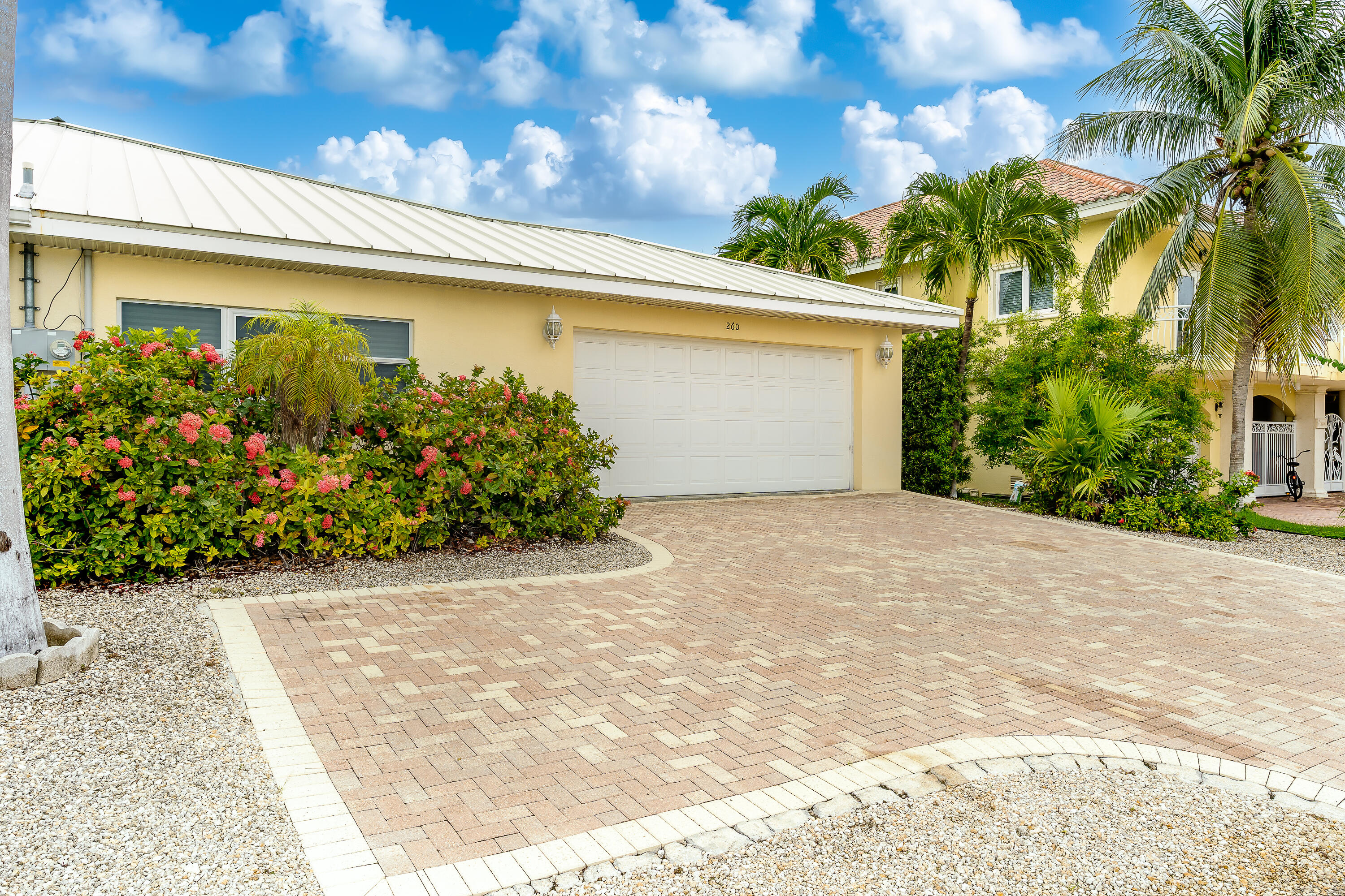 260 Sadowski Causeway Key Colony Beach, FL 33051 - Photo 37 of 50 a front view of a house with a yard and garage