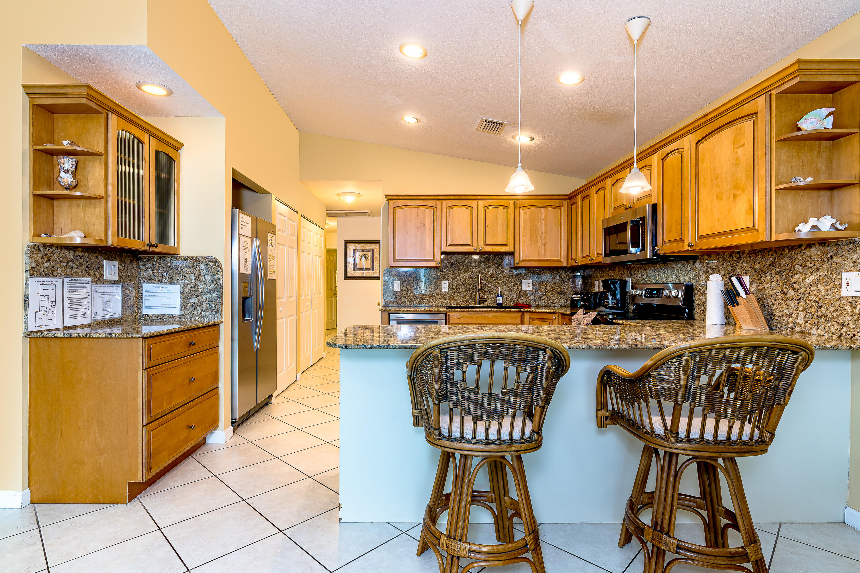 260 Sadowski Causeway Key Colony Beach, FL 33051 - Photo 7 of 50 a kitchen with stainless steel appliances kitchen island granite countertop a stove a sink a refrigerator and chairs