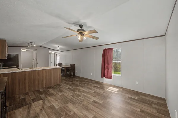 a kitchen with a table chairs sink and refrigerator