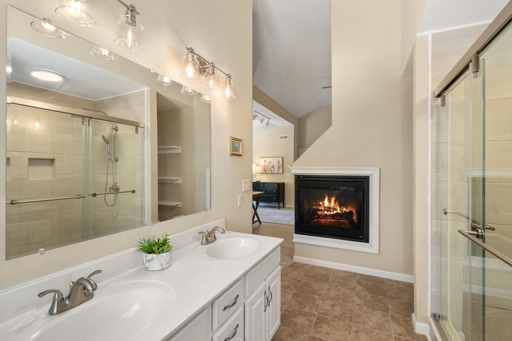 28 Patriots Boulevard, Unit 28 Hopkinton, MA 01748 - Photo 16 of 28 a bathroom with a sink and a mirror