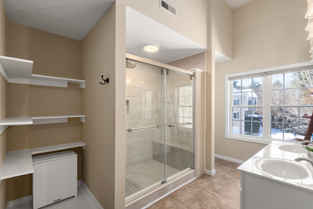 28 Patriots Boulevard, Unit 28 Hopkinton, MA 01748 - Photo 17 of 28 a bathroom with a shower and a sink