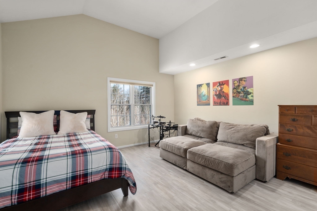 28 Patriots Boulevard, Unit 28 Hopkinton, MA 01748 - Photo 18 of 28 a bedroom with a bed and a couch
