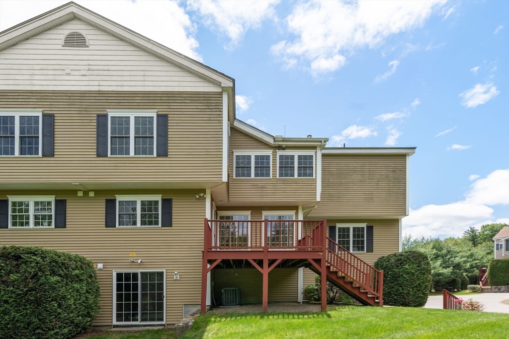 28 Patriots Boulevard, Unit 28 Hopkinton, MA 01748 - Photo 26 of 28 a front view of a house with a yard