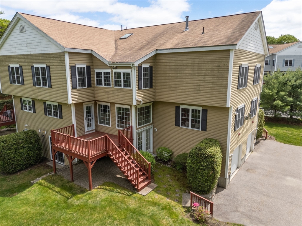 28 Patriots Boulevard, Unit 28 Hopkinton, MA 01748 - Photo 27 of 28 a front view of a house with a yard and trees