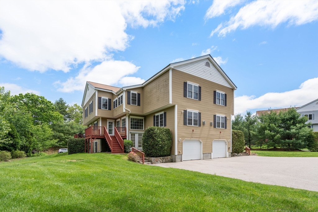 28 Patriots Boulevard, Unit 28 Hopkinton, MA 01748 - Photo 28 of 28 a front view of a house with a garden