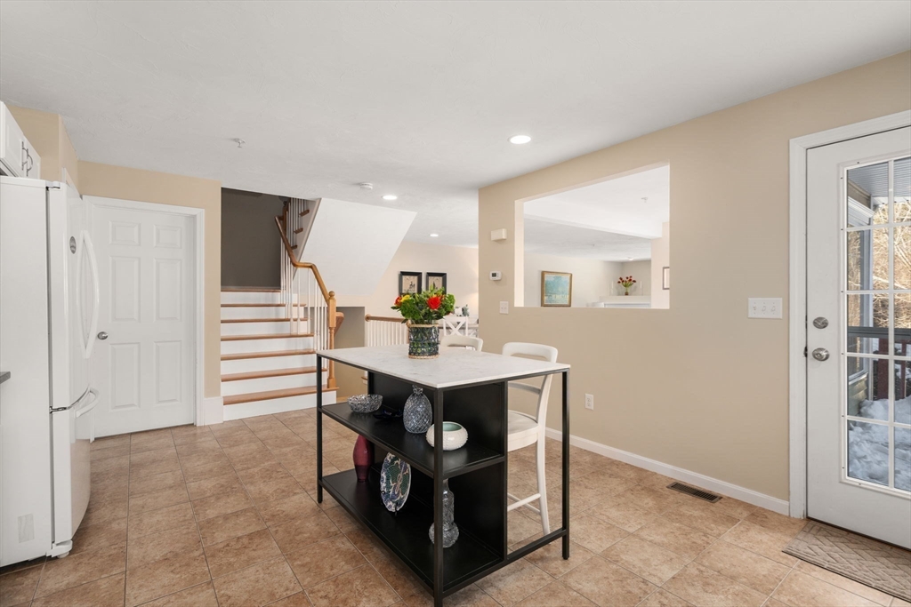 28 Patriots Boulevard, Unit 28 Hopkinton, MA 01748 - Photo 5 of 28 a view of kitchen with stainless steel appliances kitchen island a sink cabinets and wooden floor