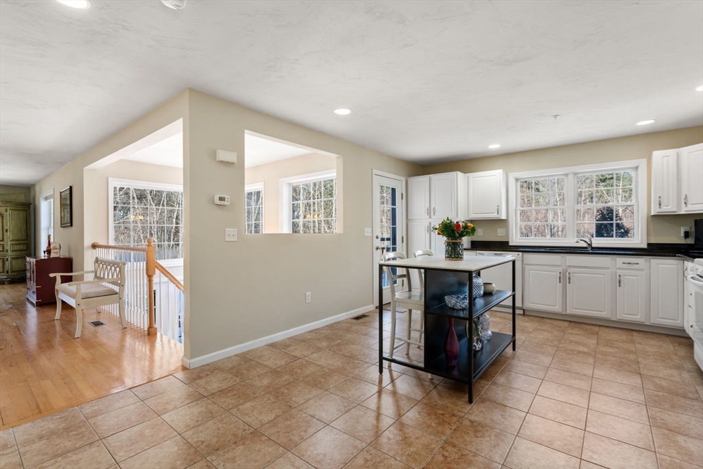 28 Patriots Boulevard, Unit 28 Hopkinton, MA 01748 - Photo 6 of 28 a kitchen with stainless steel appliances kitchen island granite countertop a refrigerator and cabinets