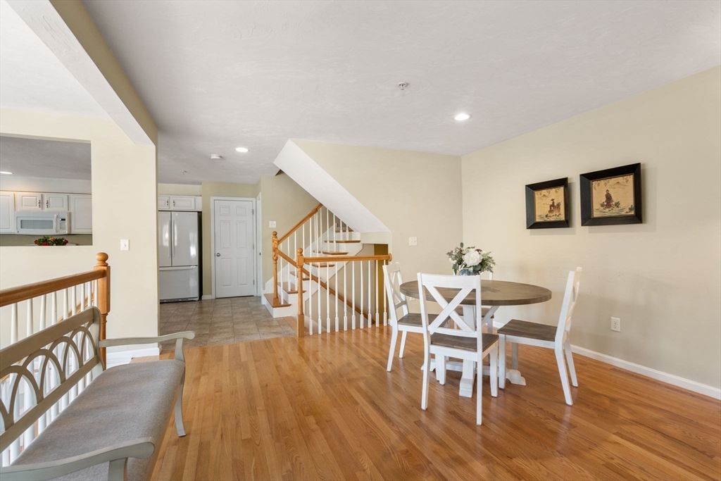28 Patriots Boulevard, Unit 28 Hopkinton, MA 01748 - Photo 7 of 28 a view of a dining room with furniture and wooden floor