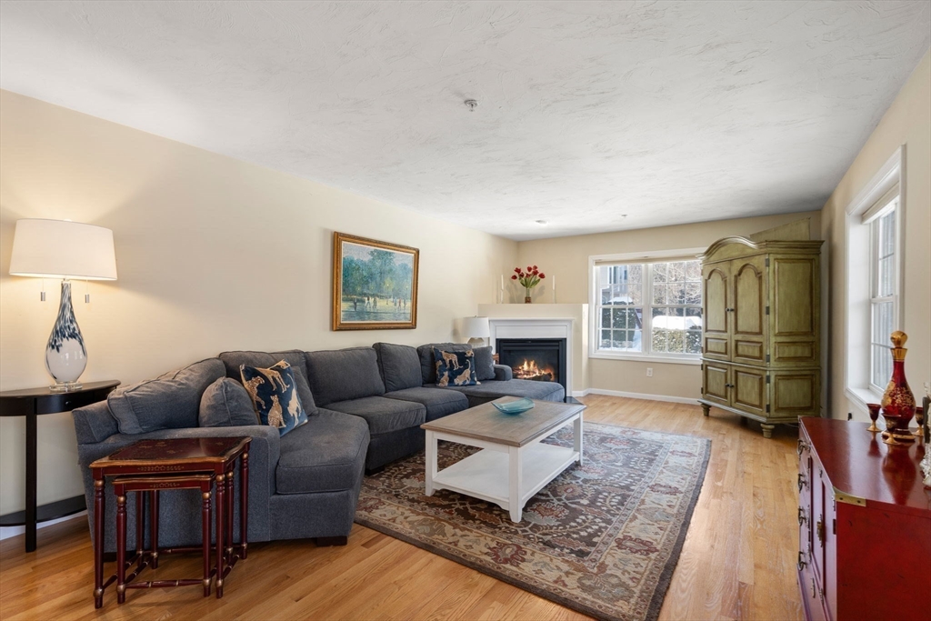 28 Patriots Boulevard, Unit 28 Hopkinton, MA 01748 - Photo 10 of 28 a living room with furniture and a fireplace