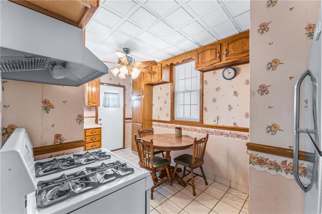 111 Sarah Street McKees Rocks, PA 15136 - Photo 6 of 30 a kitchen with stainless steel appliances a stove a sink and a dining table