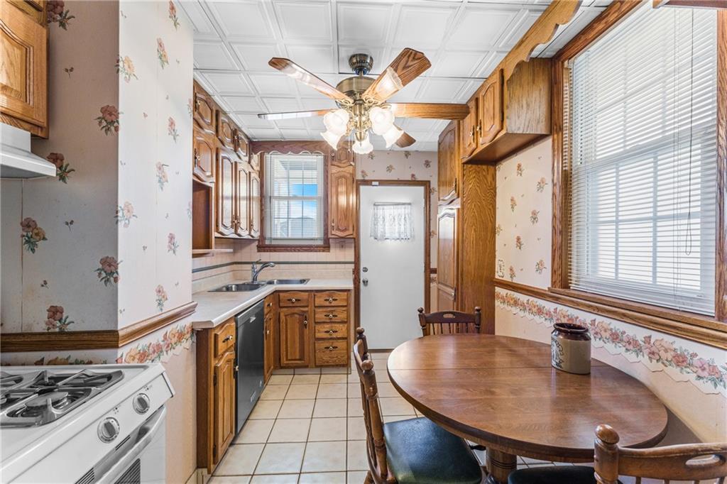 111 Sarah Street McKees Rocks, PA 15136 - Photo 8 of 30 a kitchen with stainless steel appliances granite countertop a sink stove and refrigerator