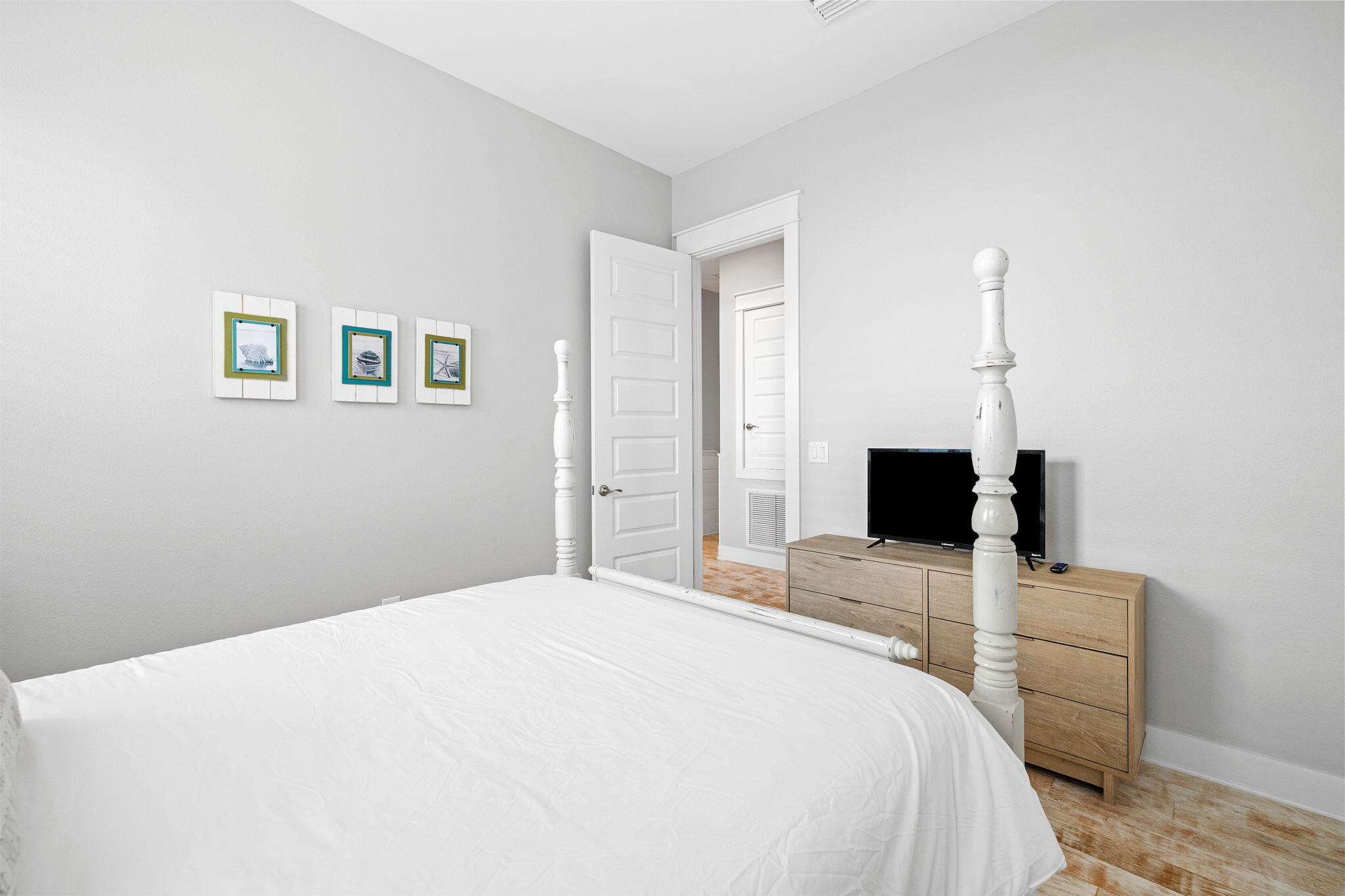 223 Milestone Dr Inlet Beach, Unit B Inlet Beach, FL 32461 - Photo 24 of 58 a bedroom with a bed and a flat screen tv