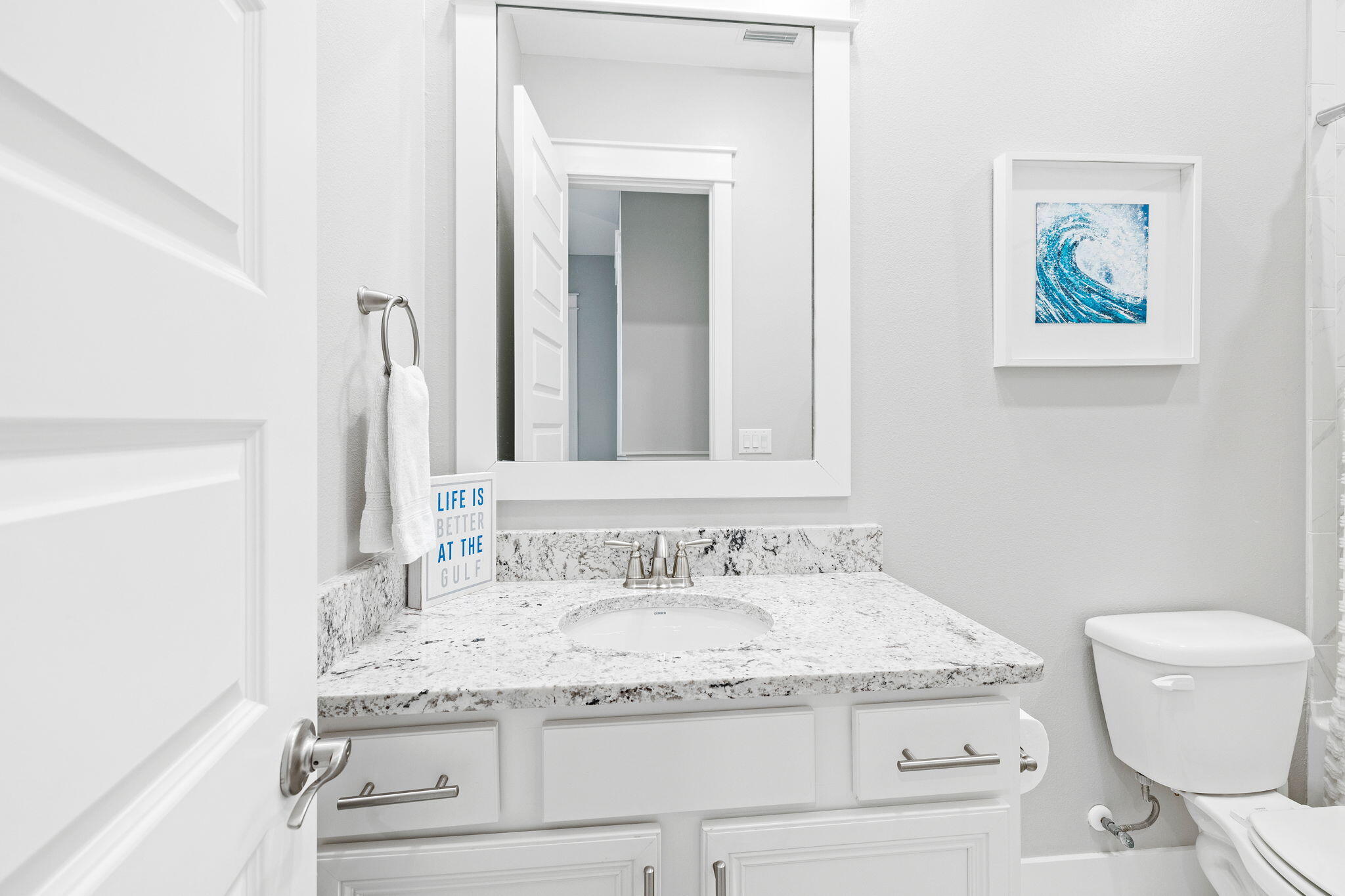 223 Milestone Dr Inlet Beach, Unit B Inlet Beach, FL 32461 - Photo 25 of 58 a bathroom with a granite countertop sink and a mirror