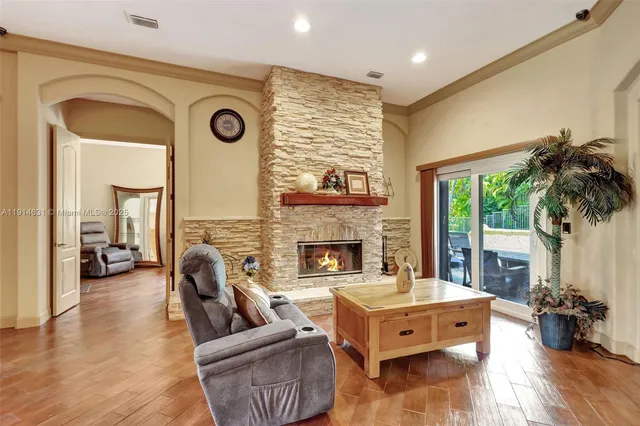 a living room with furniture fireplace and flat screen tv