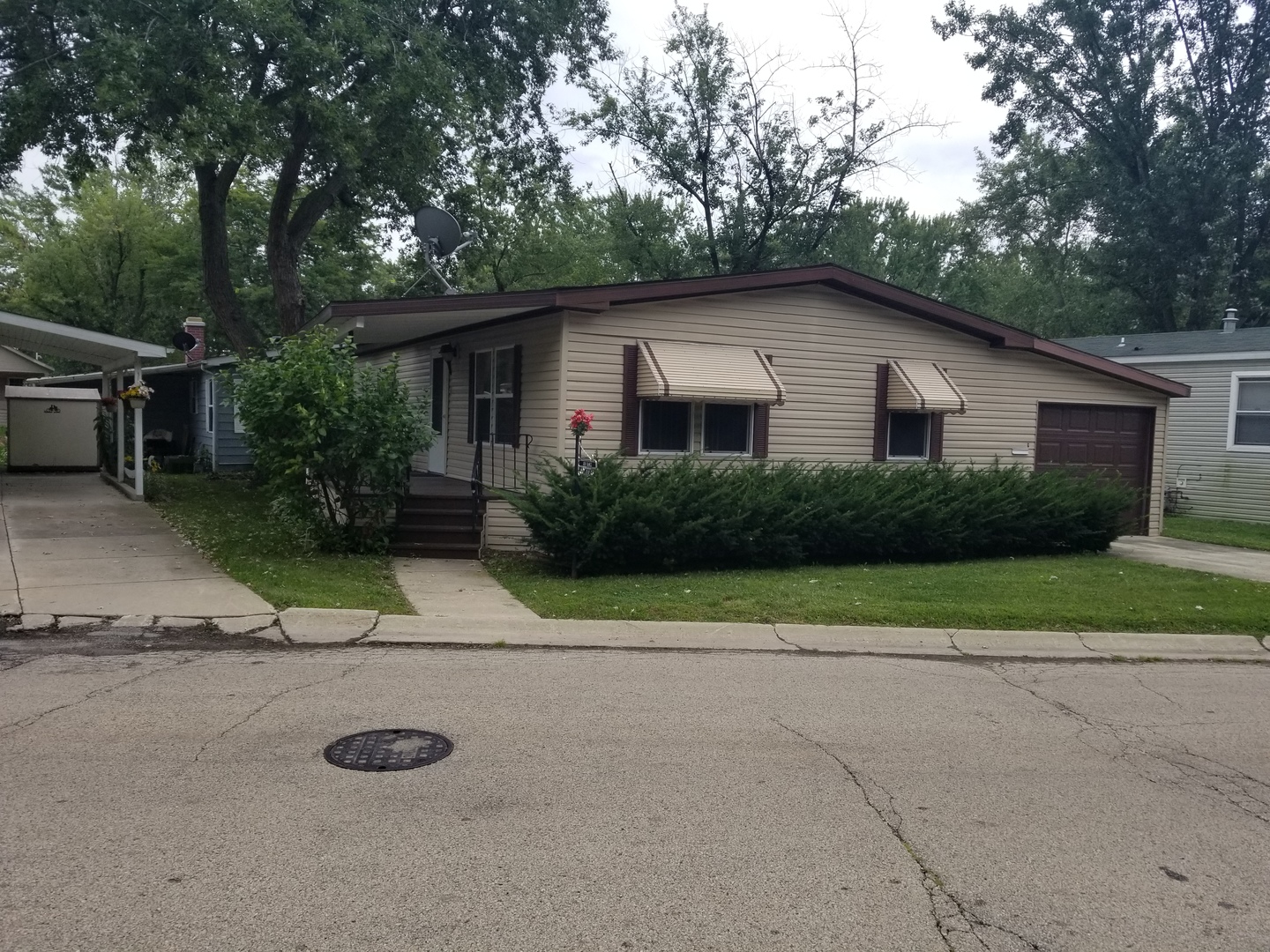 259 Parkwood Road Elgin, IL 60123 - Photo 1 of 18 a house with trees in the background