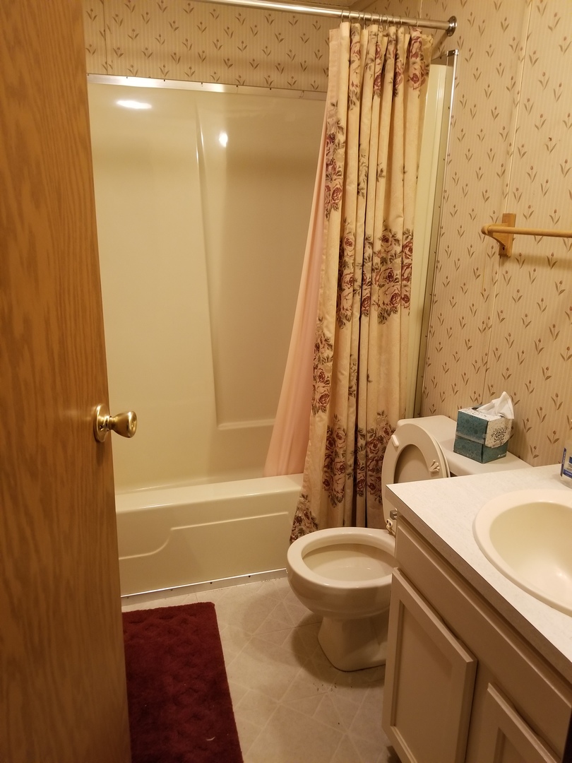 259 Parkwood Road Elgin, IL 60123 - Photo 14 of 18 a bathroom with a sink toilet and shower