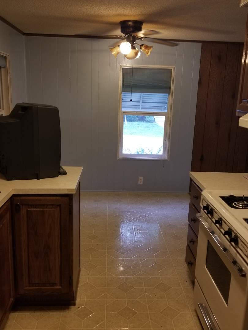 259 Parkwood Road Elgin, IL 60123 - Photo 7 of 18 a kitchen with a stove and a microwave