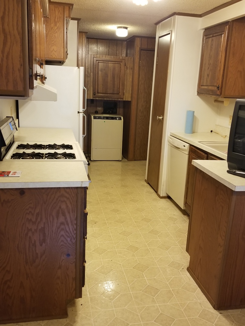 259 Parkwood Road Elgin, IL 60123 - Photo 8 of 18 a kitchen with a refrigerator sink stove and cabinets