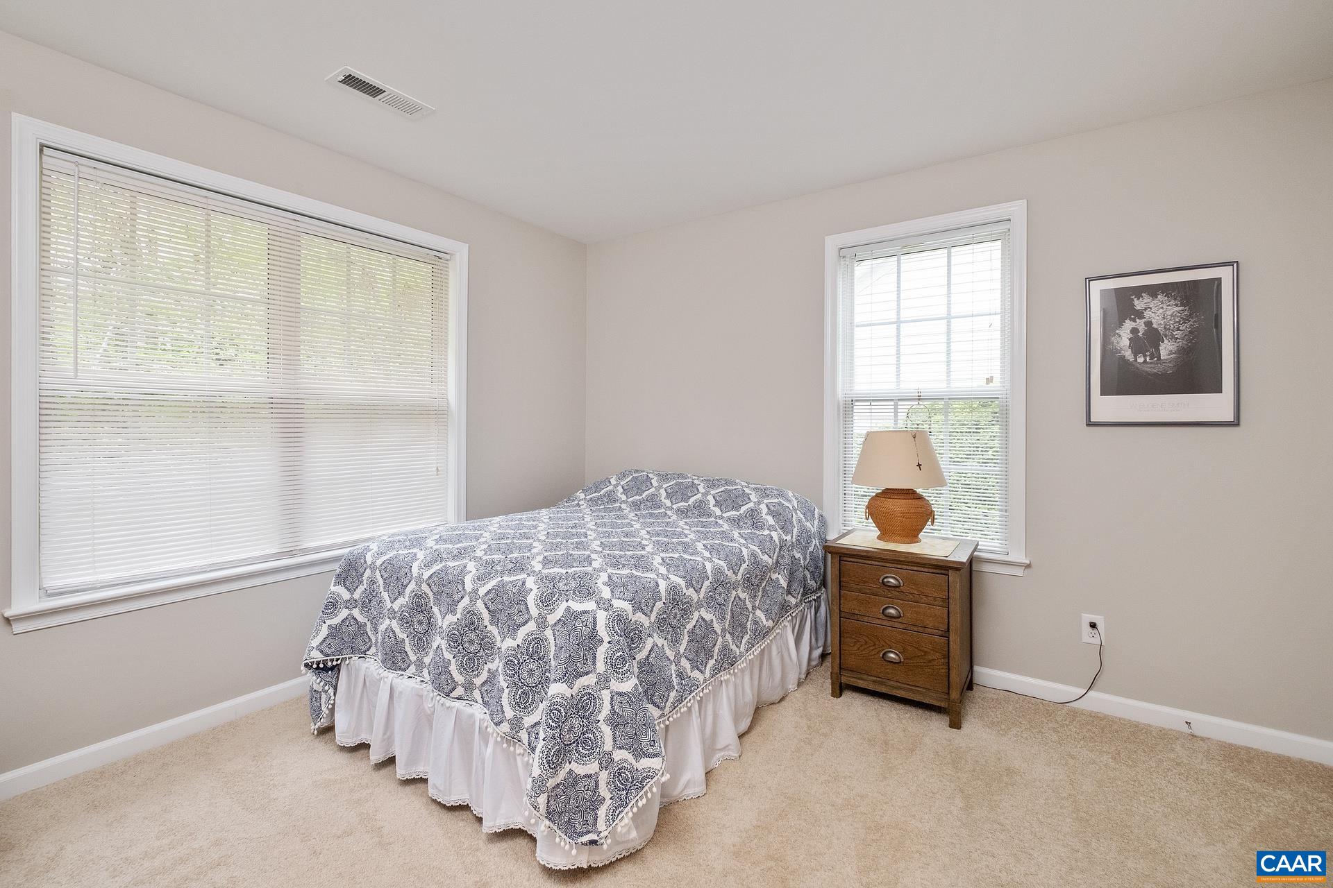 2598 Ravenscroft Way Charlottesville, VA 22911 - Photo 12 of 17 a bed sitting in a bedroom next to a window