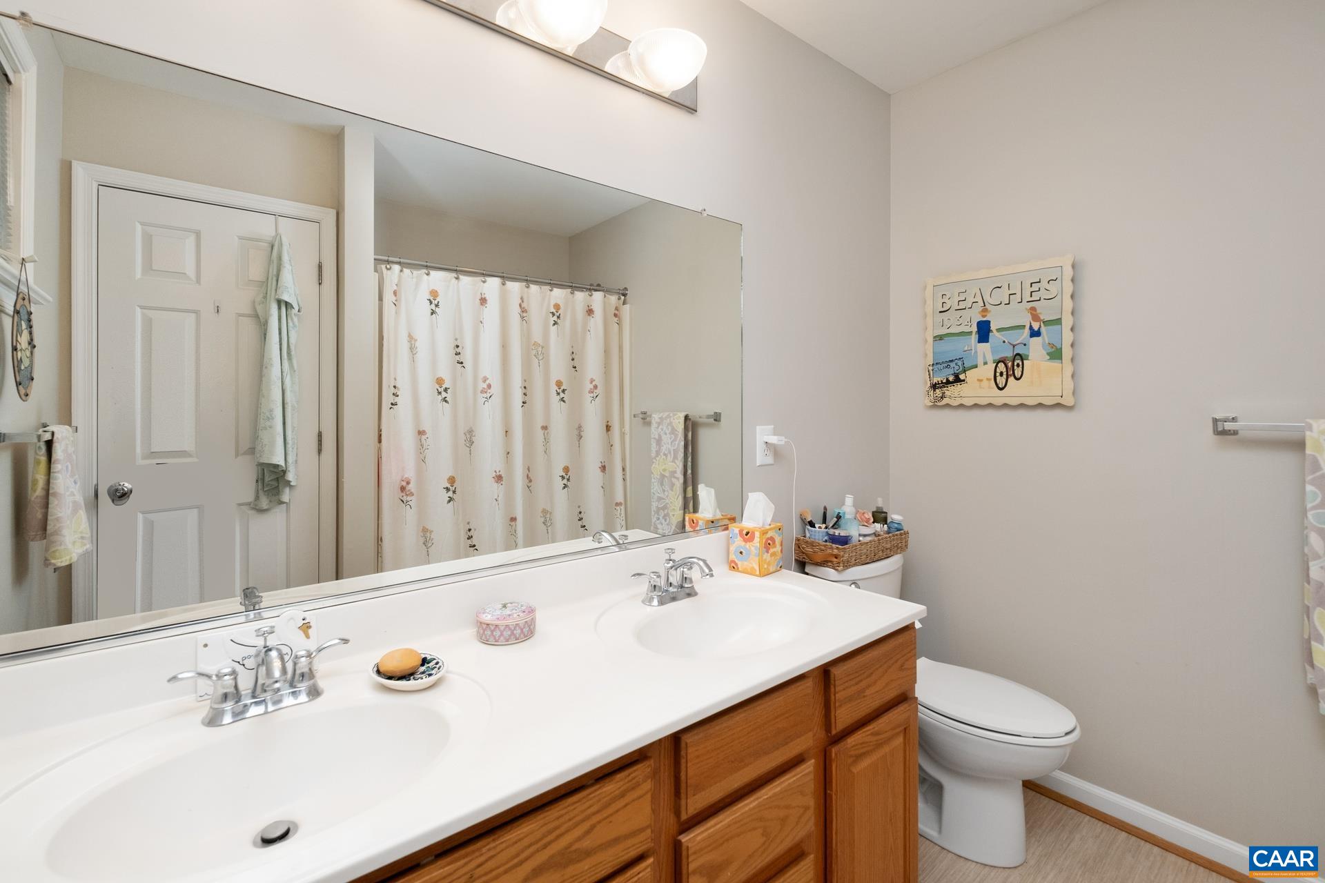 2598 Ravenscroft Way Charlottesville, VA 22911 - Photo 10 of 17 a bathroom with a sink a toilet and shower curtain