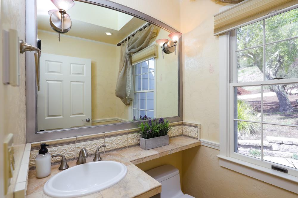 223 Nehf Lane Soquel, CA 95073 - Photo 12 of 34 a bathroom with a granite countertop sink and a mirror