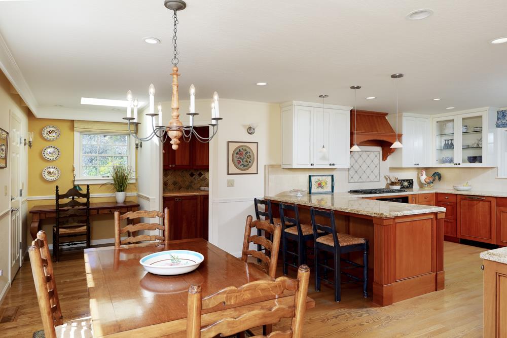 223 Nehf Lane Soquel, CA 95073 - Photo 5 of 34 a kitchen with stainless steel appliances granite countertop a stove a refrigerator a kitchen island a dining table and chairs with wooden floor
