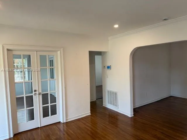 a view of empty room with wooden floor