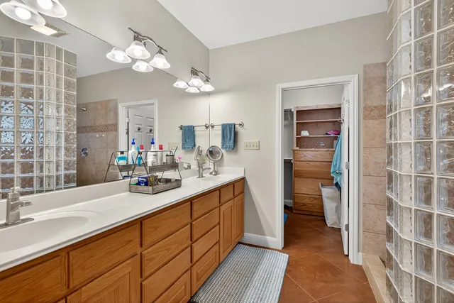 a bathroom with a sink double vanity and a mirror