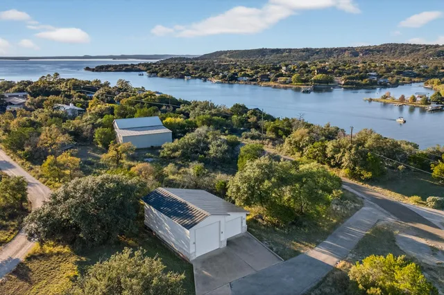 an aerial view of a house with a lake view